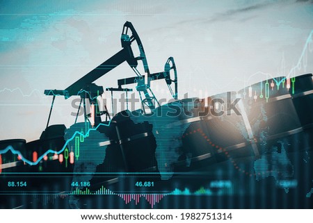 Oil pumping machinery in operation with barrels and digital screen with world map and financial chart graphs and indicators, natural resources stock market concept. Double exposure Royalty-Free Stock Photo #1982751314