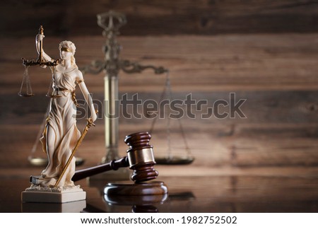 Law and justice symbols. Brown wooden background. Place for text.