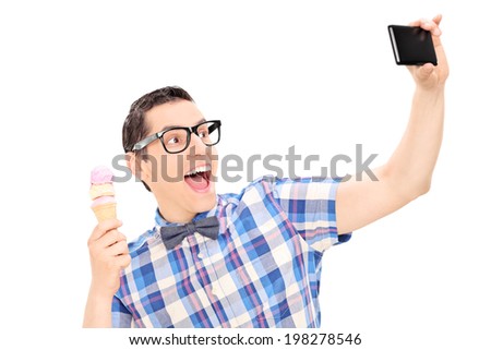 Excited man holding ice cream and taking selfie isolated on white background