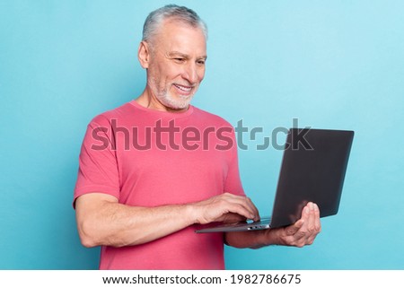 Photo portrait of bearded man pink t-shirt using laptop browsing internet isolated pastel blue color background