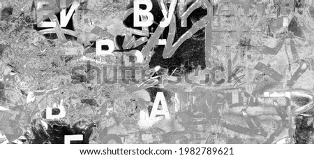 Grunge Wide Background with Old Torn Posters. Urban Graffiti Wall Texture. Grungy Ripped Wall with Torn Posters and Ads Background. Panoramic Urban Wallpaper. Graffiti Wall Texture. Royalty-Free Stock Photo #1982789621