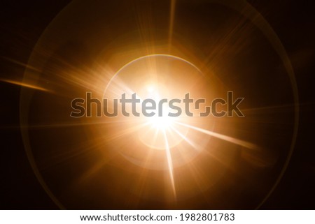 Easy to add lens flare effects for overlay designs or screen blending mode to make high-quality images. Abstract sun burst, digital flare, iridescent glare over black background. Royalty-Free Stock Photo #1982801783