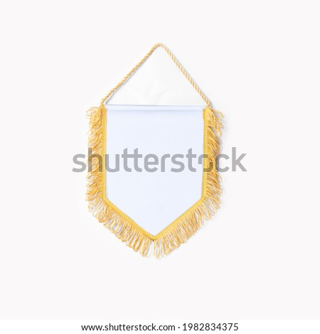 Empty blank Pennant white fabric with gold fringes on white background.