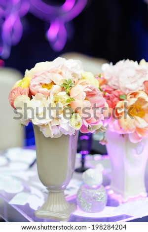 Pastel flowers bouquet in vase on dark background
