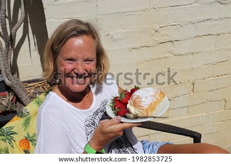 Woman eating strawberry and vanilla cake