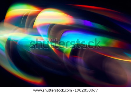 Blurred Light painting one exposure in camera. light glares with a spectral gradient on a dark background. Multicolored abstract colorful line. Unusual light effect. Royalty-Free Stock Photo #1982858069