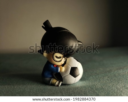 Cute Baby Conan holding a football
