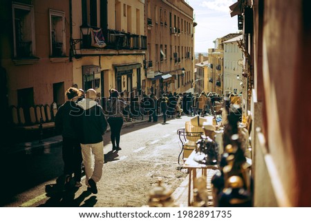 People walking walking down Madrid´` Rastro. Street market in madrid