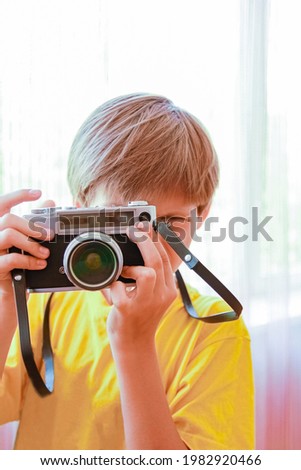 happy boy with a camera on the background