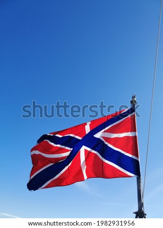Huys-the fortress flag fluttering in the wind on the background of the blue sky. naval flag of russia fortresses.bow flag of warships  Royalty-Free Stock Photo #1982931956