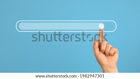 Female hand with a raised forefinger and a virtual loading bar. Abstract future background, close up Royalty-Free Stock Photo #1982947301
