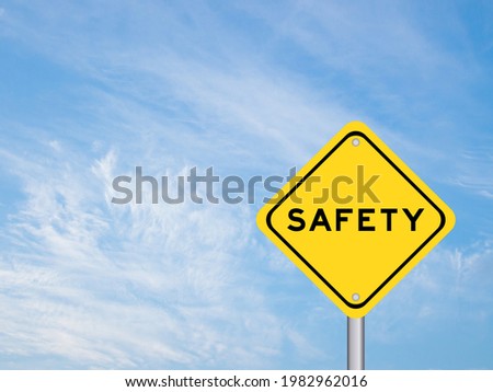 Yellow color transportation sign with word safety on blue sky background