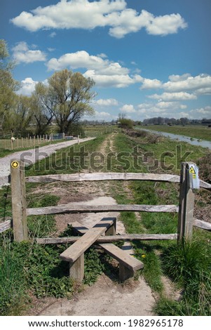 A stile and fence in farmland near Alfriston, East Sussex Royalty-Free Stock Photo #1982965178