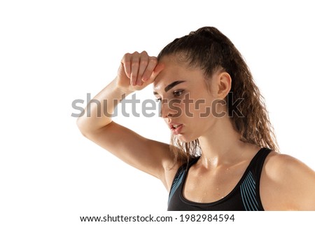 Close-up portrait of young girl female athlete isolated over white background.
