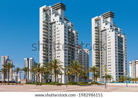 New modern high-rise residential buildings under blue sky in city of Ashdod, Israel. Royalty-Free Stock Photo #1982986151