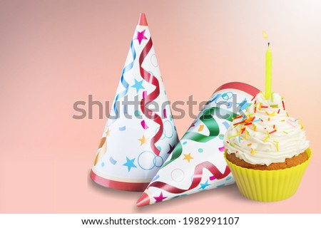 Sweet birthday cupcake with candle, birthday gift and party hat on the desk.