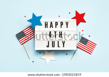 Happy Independence day July 4th.Lightbox with the text Happy July 4th,american flags and stars on a blue background