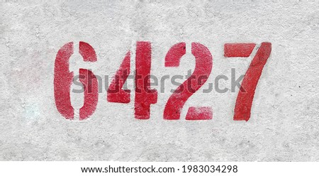 Red Number 6427 on the white wall. Spray paint.