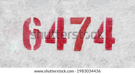 Red Number 6474 on the white wall. Spray paint.