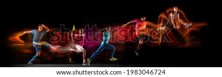 Development of motions of different kinds of sport games. Young men in action isolated over dark background in neon mixed colored light. Flyer. Concept of sport, competition, championship. Copy space Royalty-Free Stock Photo #1983046724