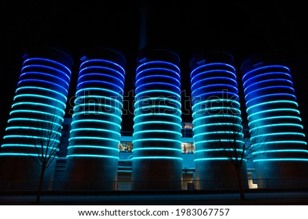 silos with blue ligth stripes in the night