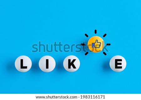 Like icon and the word like written on table tennis balls. Social media interaction, likeability or like us on internet concept.