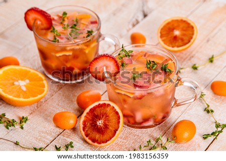 refreshing strawberry and citrus cocktails on a white wooden table from the top view
