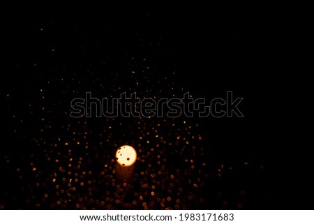 Night landscape, lantern in a rainy window with many small shades of light