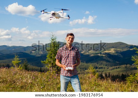 Aerial drone footage shooting of summer Carpathins. Man operating copter controller in mountains. Tourist filming nature