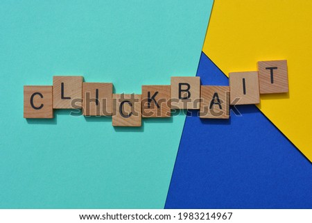 Clickbait, business buzzword in wood alphabet letters isolated on multi coloured background