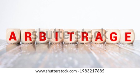 ARBITRAGE word made with building blocks. Royalty-Free Stock Photo #1983217685