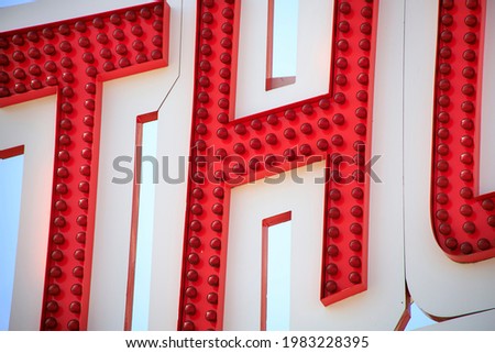 Big bright letters on a sign at a carnival in the summer