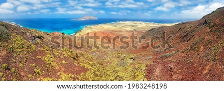View into the volcanic crater of Montana Bermeja, island Monta Clara in the background, La Graciosa, Lanzarote, Canary Islands, Spain