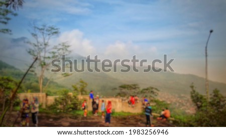 blur photo of blue sky and the mountains covered in morning mist