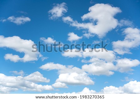 Fluffy clouds and clear blue sky in the nice day.