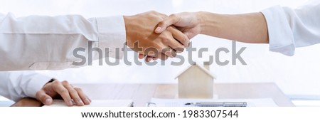 home loan insurance. 
Real estate broker and client  sign contract insurance agreement document. Business meeting