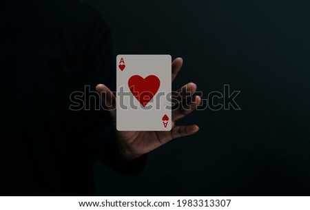 Ace Heart Playing Card. Player or Magician Levitating Poker Card on Hand. Metaphor of Love, Happiness and begin a Good Relationship.Front View. Closeup and Dark Tone