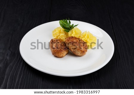 Chicken meat cutlet with mashed potatoes on white plate