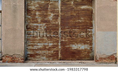 rusty industrial metal shutter on facade