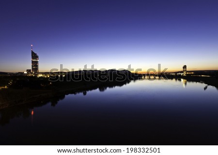 Cityscape of Vienna with the so called Millennium Tower at the Danube River in the summer at dusk with the very last sunshine.