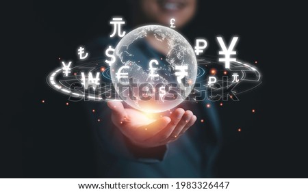 Global currency exchange concept, Hand holding world with virtual line effect and dollar yuan yen euro and pound sterling sign. Royalty-Free Stock Photo #1983326447