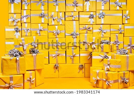 Room full of many packed yellow gifts, copy space, no people. for banner advertisement. holiday, celebration, part, birthday concept Royalty-Free Stock Photo #1983341174