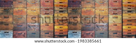 Beekeeper beekeeping background banner panorama wallpaper - Wall texture made of many old rustic wooden beehives stacked on top of each other