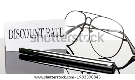 Text DISCOUNT RATE on paper on light background with pen and glasses. Business