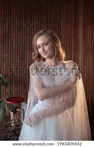 young and beautiful bride blonde in a dark interior.