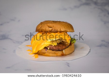 Burgers placed on a marble backdrop.