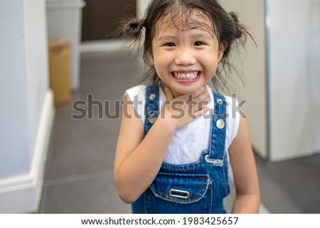 portrait of smiling Asian little girl at home
