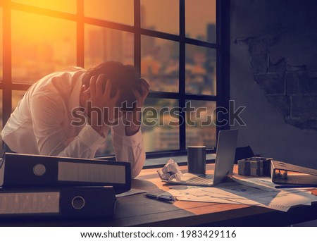 Business people who are stressed and worried about making mistakes at work Economic downturn and going bankrupt Royalty-Free Stock Photo #1983429116