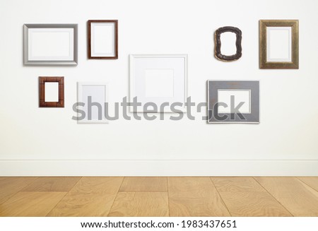 Mock up empty white frame background. Different decorative empty frames for a photo or painting in a light Scandinavian minimalist interior on a white clean wall.