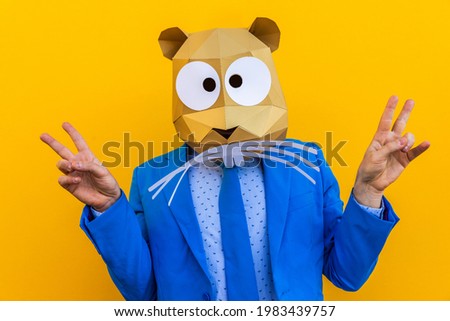 Cool man wearing 3d origami mask with stylish colored clothes - Creative concept for advertising, animal head mask doing funny things on colorful background